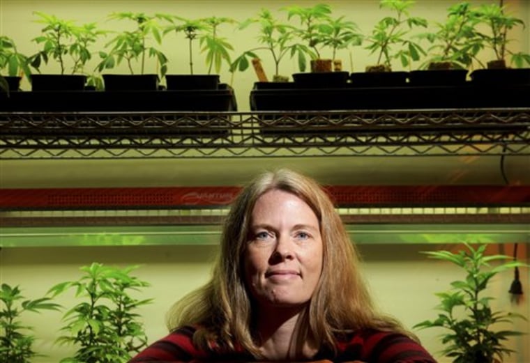 Marijuana advocate Debby Goldsberry sits among pot plants in Oakland, Calif., on Saturday. Goldsberry founded Berkeley Patients Group, one of the Bay Area's first marijuana dispensaries, more than 10 years ago. 